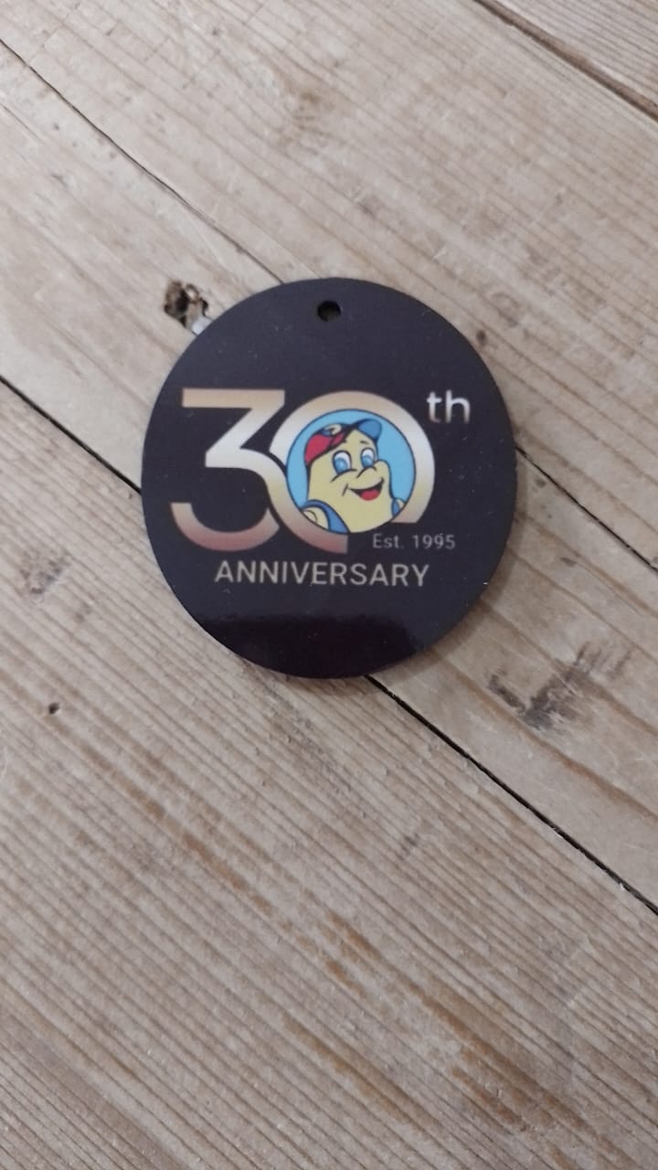 Round black 30th-anniversary promotional badge
