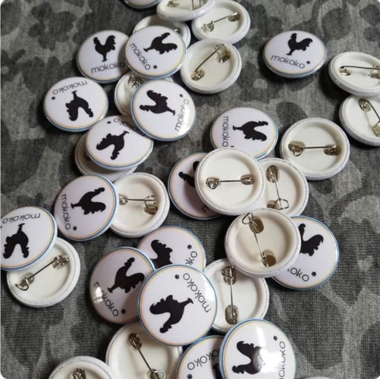 Collection of round white and black animal-themed keyrings