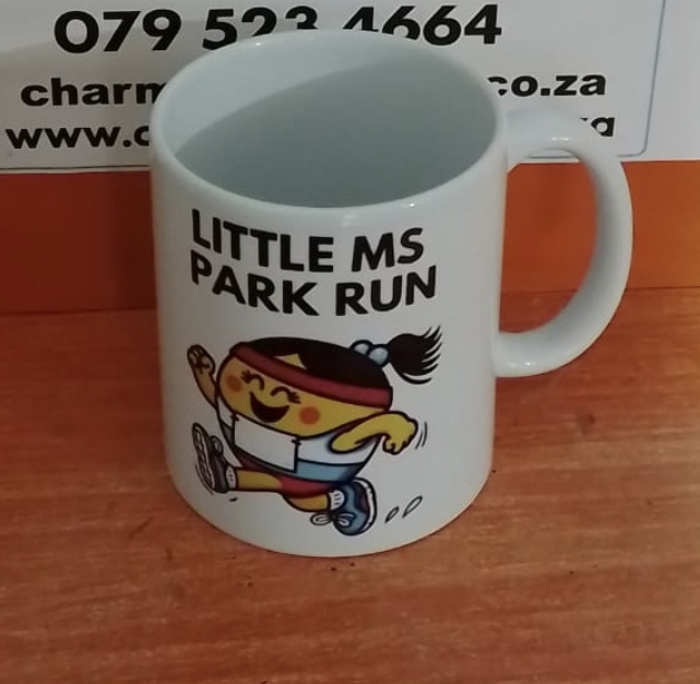 White mug printed with a colourful running-event design