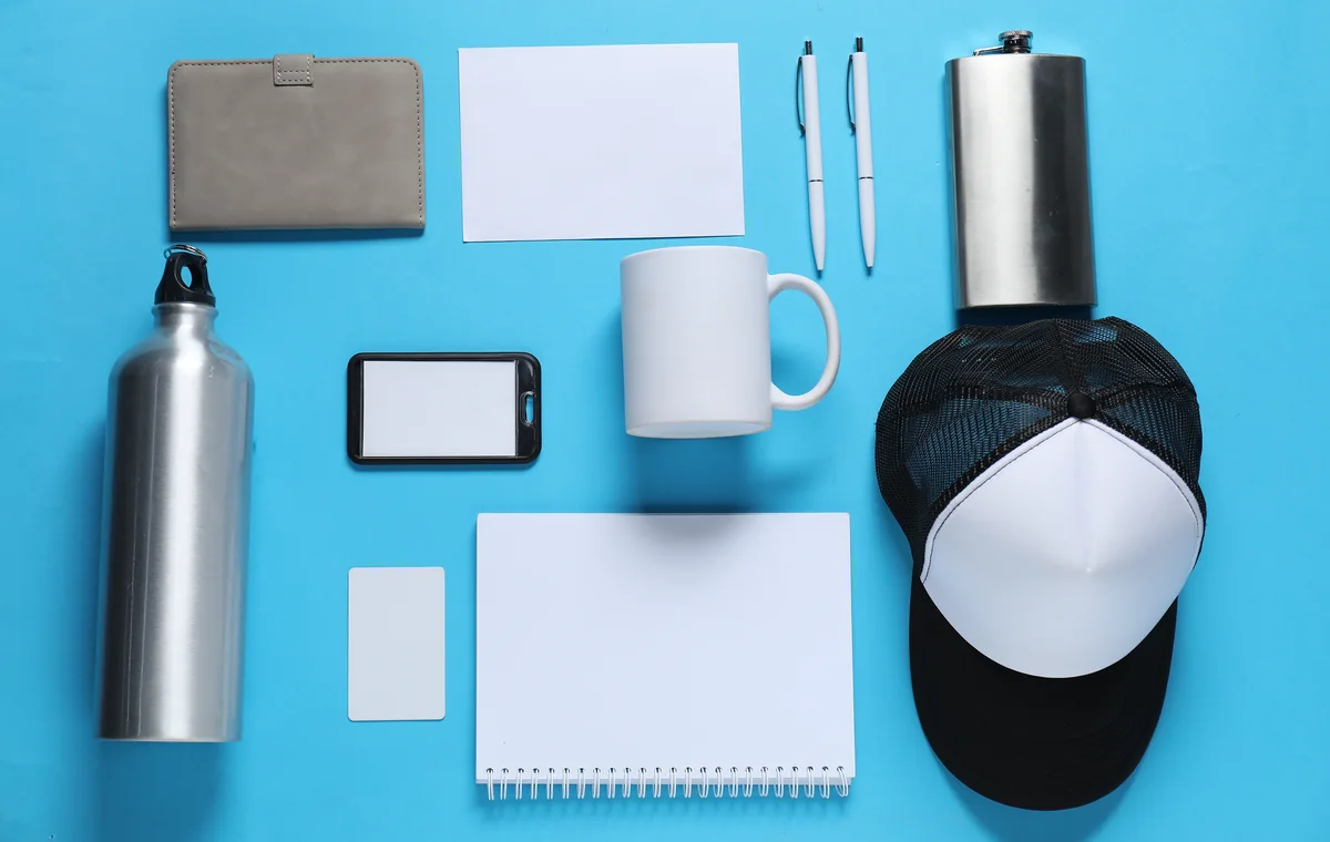 Blank mug, cap, bottle and desk accessories arranged for custom branding